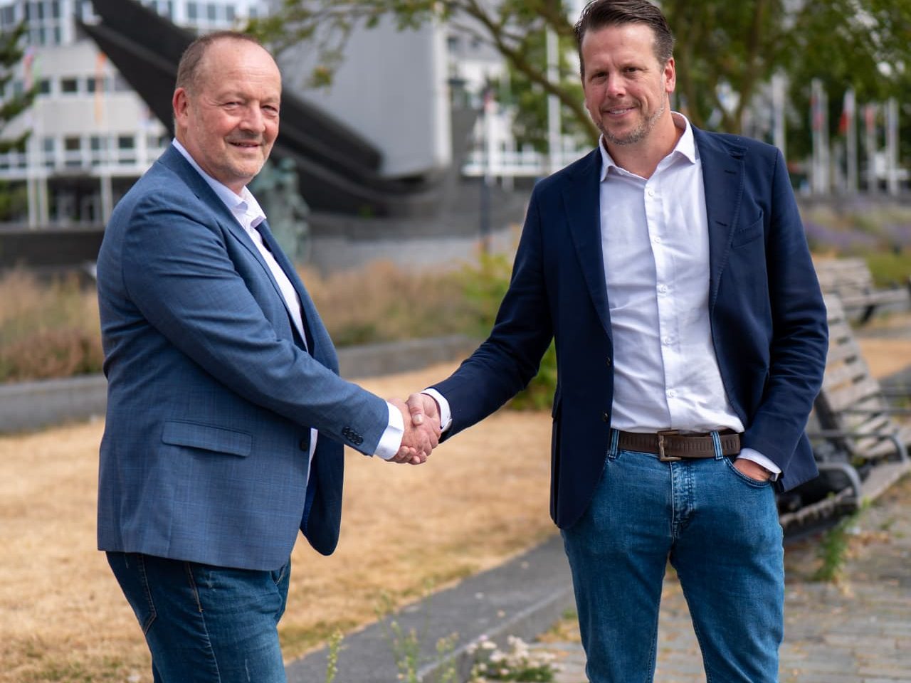 Intercompany Solutions directors shaking hands outside the World Trade Center in Rotterdam
